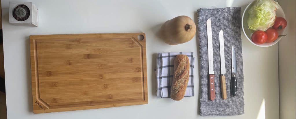  a table with cutting board and knives