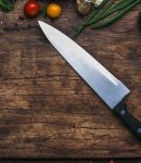 Best chef knife on a cutting board with ingredients