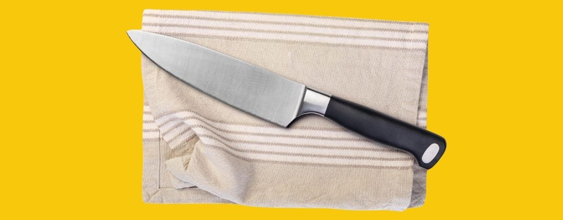 Chef-knife-on-a-kitchen-towel-scaled