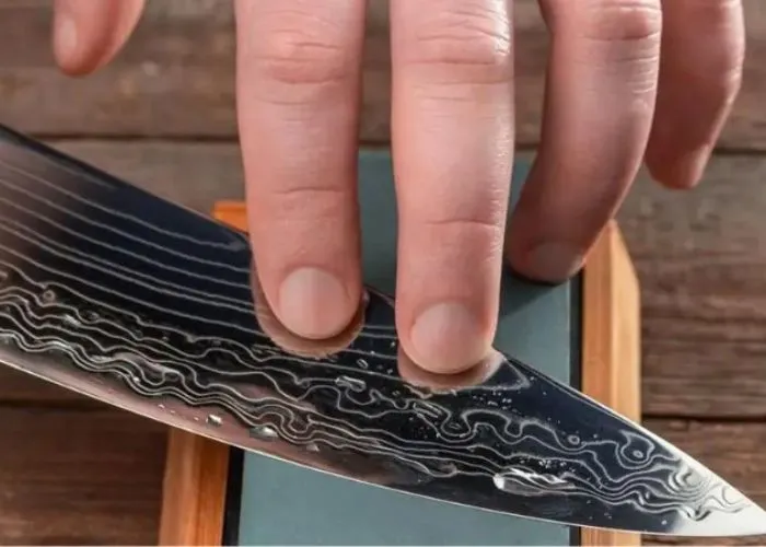 Man-sharpening-a-Damascus-chef-knife - Mobile