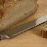 A bread knife and a bread on a cutting board