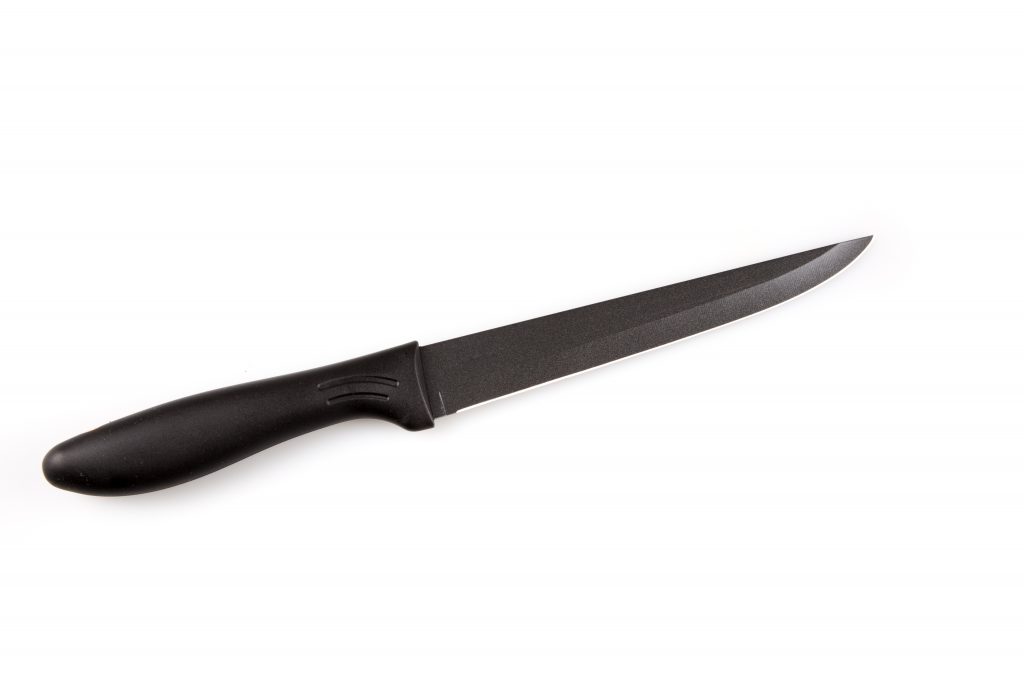 A utility knife with a black handle on a white background