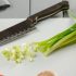 Santoku-chef-knife-and-vegetables-on-a-white-cutting-board-scaled