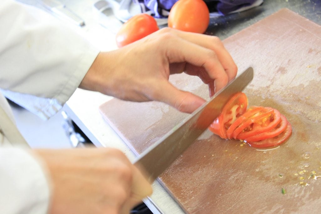 Slicing tomatoes with a slicing knife