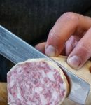 Slicing the goose salami with a slicing knife