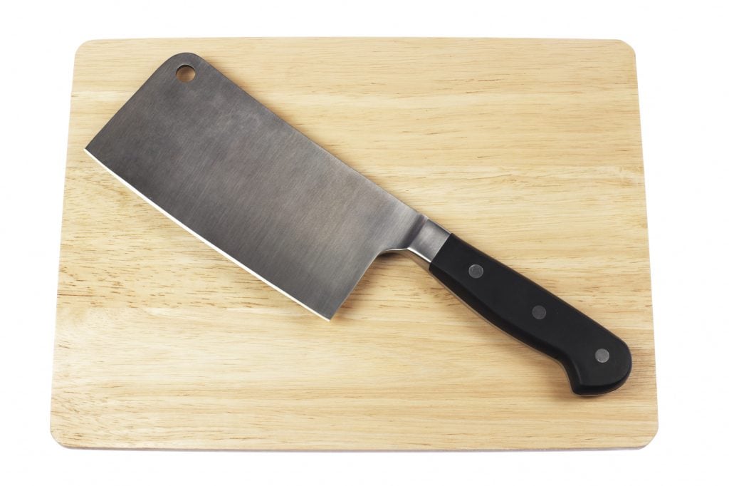 A meat cleaver on a cutting board