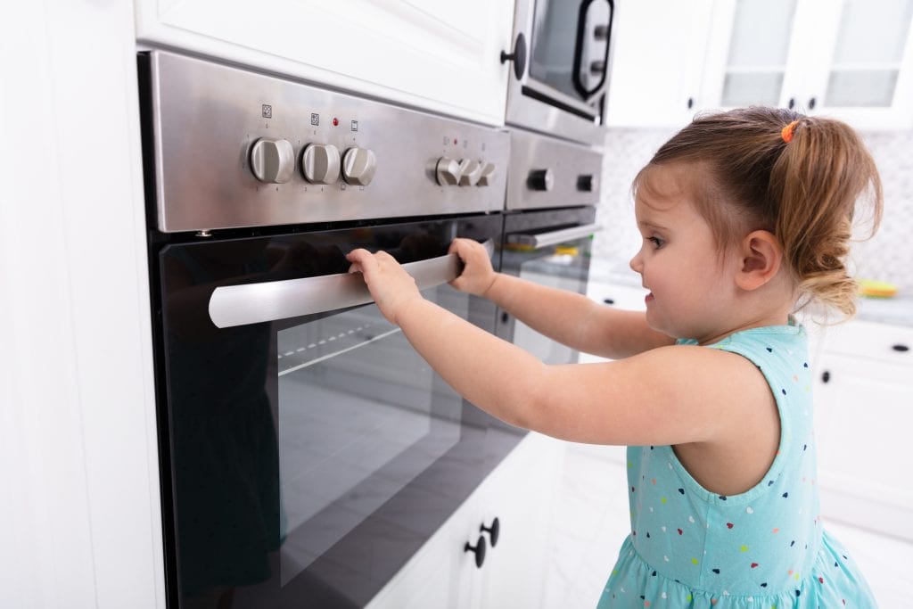 Little Girl Playing With Electric Microwave Oven In