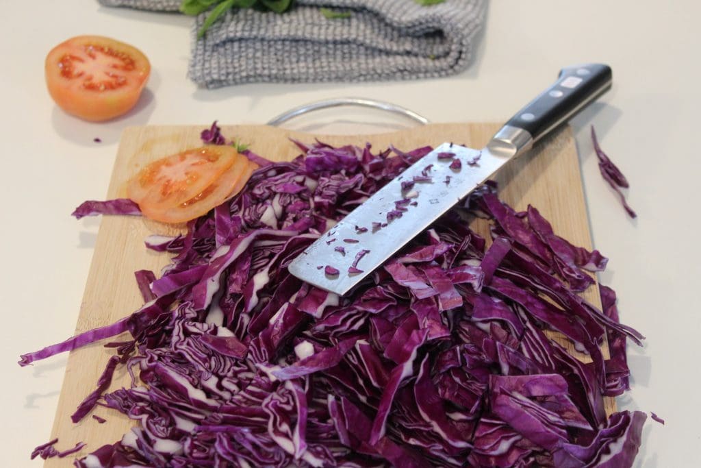 Tojiro Nakiri Knife, Chopped Cabbage, and Sliced Tomato on a Cutting Board