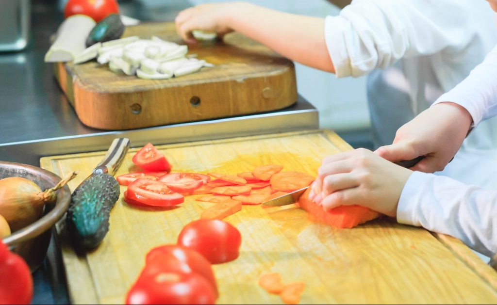 children cooking lunch in a restaurant kitchen.