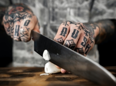 A chef cutting garlic with a chef’s knife