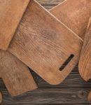 Top view of wooden cutting boards on brown tabl