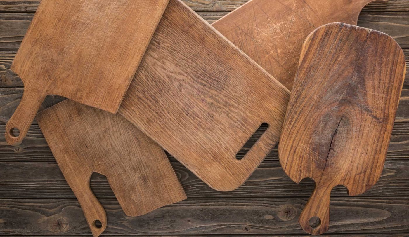 Top view of wooden cutting boards on brown tabl
