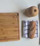 a table with cutting board and knives on