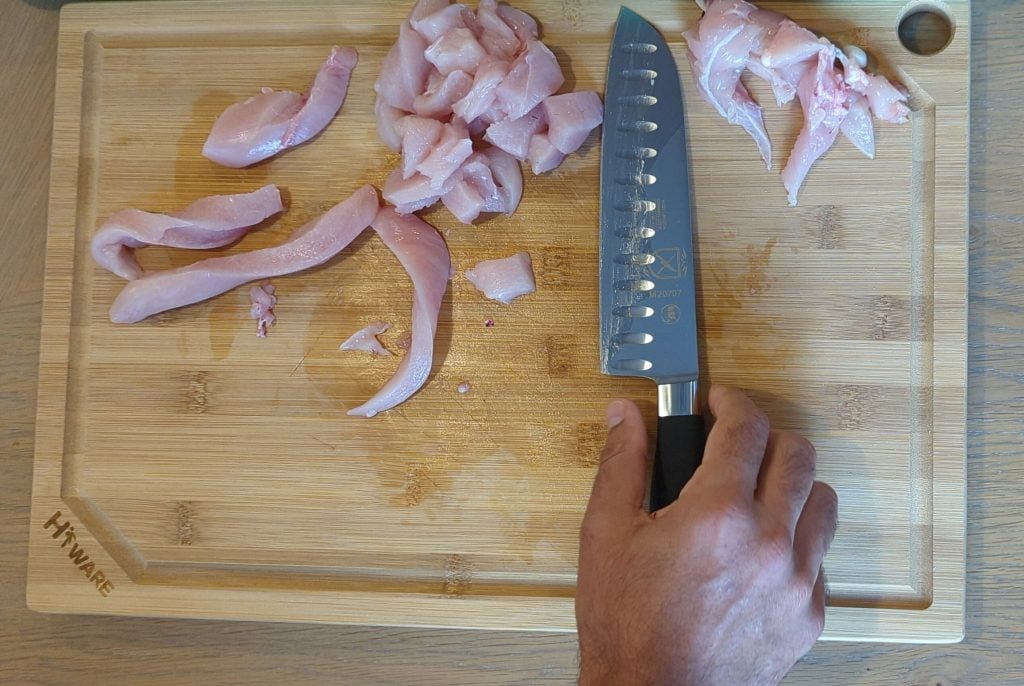 https://knivesacademy.com/wp-content/uploads/2022/06/Mercer-Genesis-Santoku-and-cutted-and-sliced-chicken-breast-on-a-cutting-board-1024x686.jpg