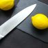 knife and a lemon on cutting board