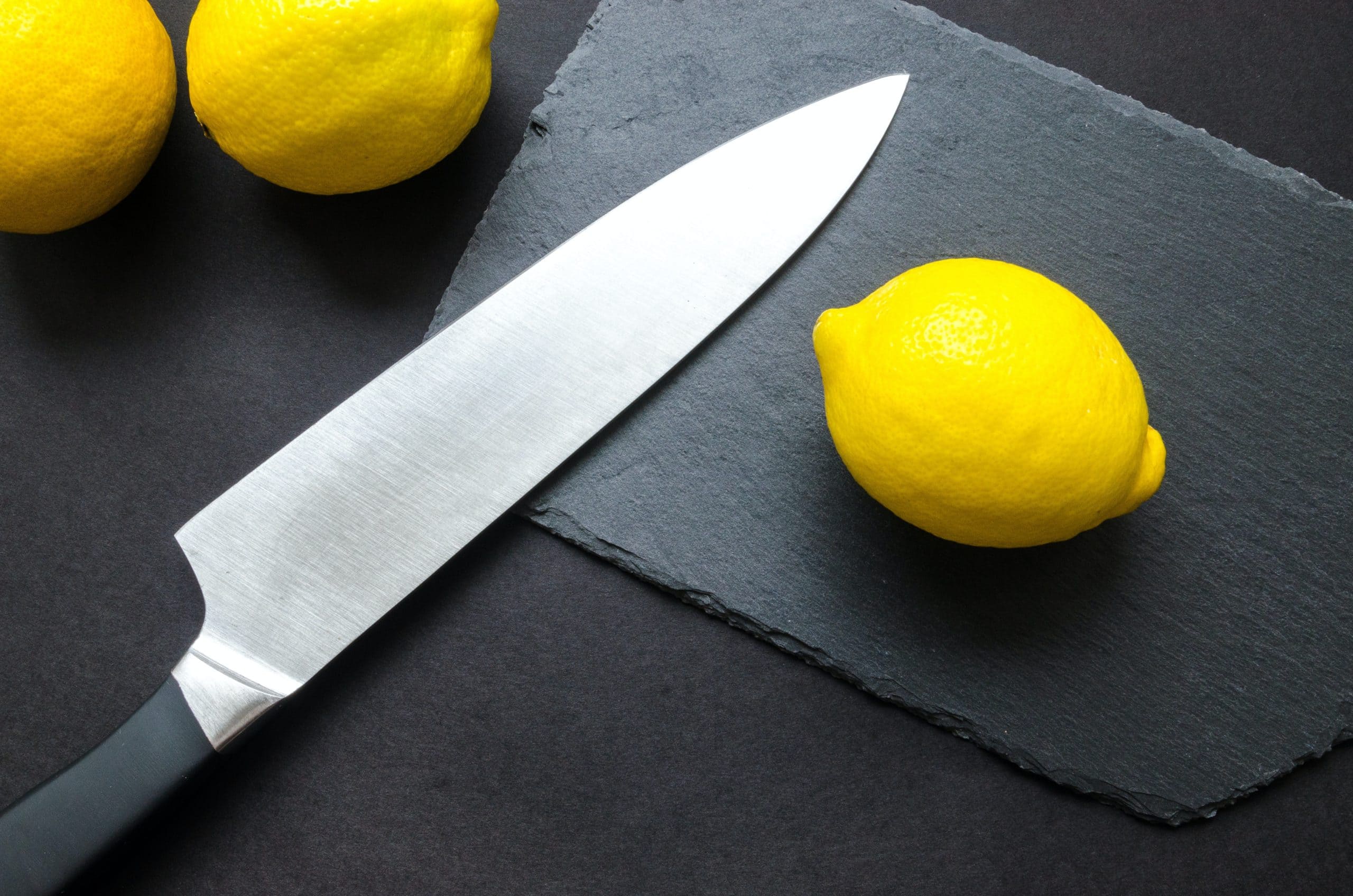 knife and a lemon on cutting board