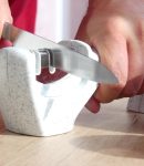 Manual sharpening of a knife in a special sharpener