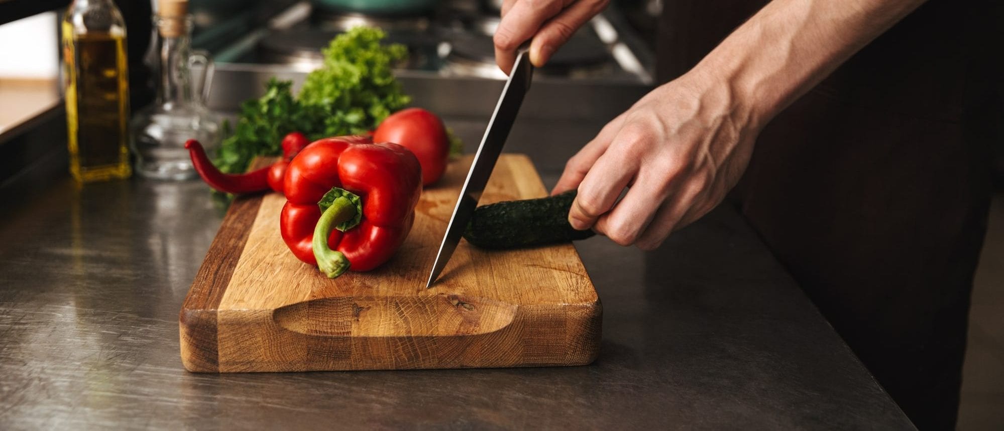 Close up of a man hands chopping vegetables on