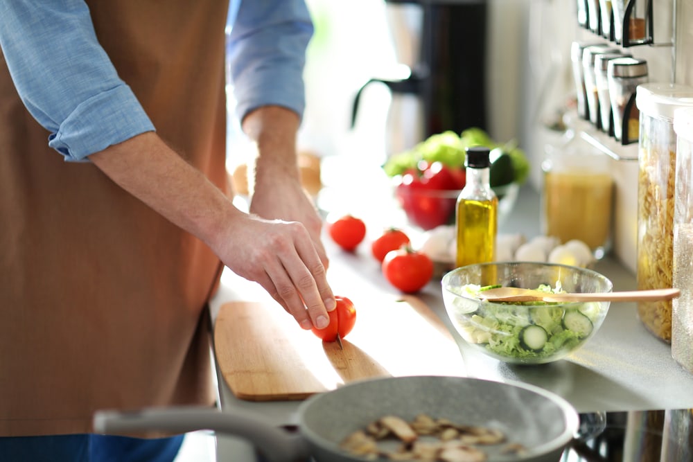 Man cooking dinner in kitchen