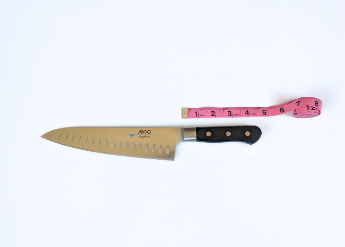 The Mac Professional 8 Inch Hollow Edge Chef Knife, horizontal on a white background measured with a pink ruler at 4.75 inches