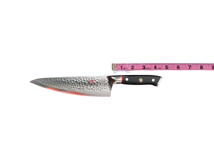 The Dalstrong, horizontal on a white background while measured with a pink ruler at