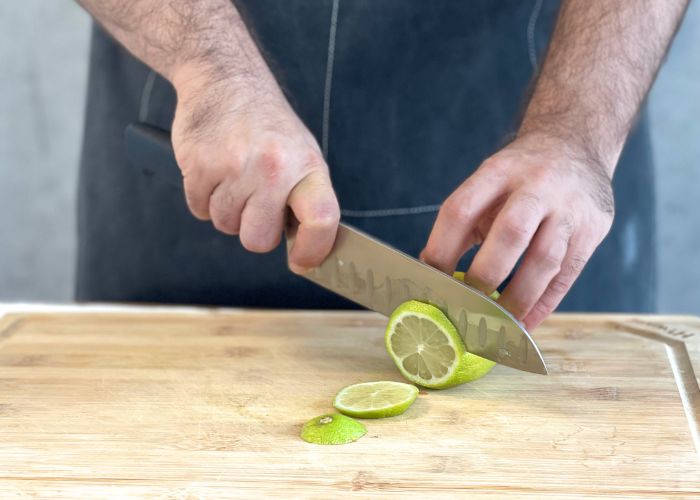 The Mercer, held by our tester, while cutting a lemon on a cutting board